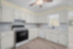 Finished kitchen with new cabinets, countertops, and flooring
