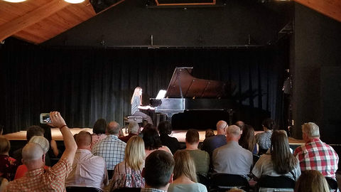 Teenage Piano student performs in front of audience at Ice Piano Studio's Spring Recital