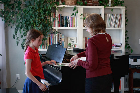 Piano teacher instructs student in piano lesson in Erie, CO