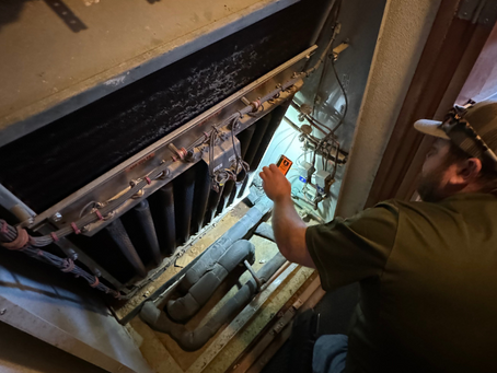 Re-Coil HVAC Tech measuring dimensions for replacement coil