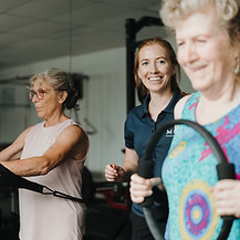 Exercise physiologist instructing 2 women in clinical pilates at Move Sports Physio Geelong West