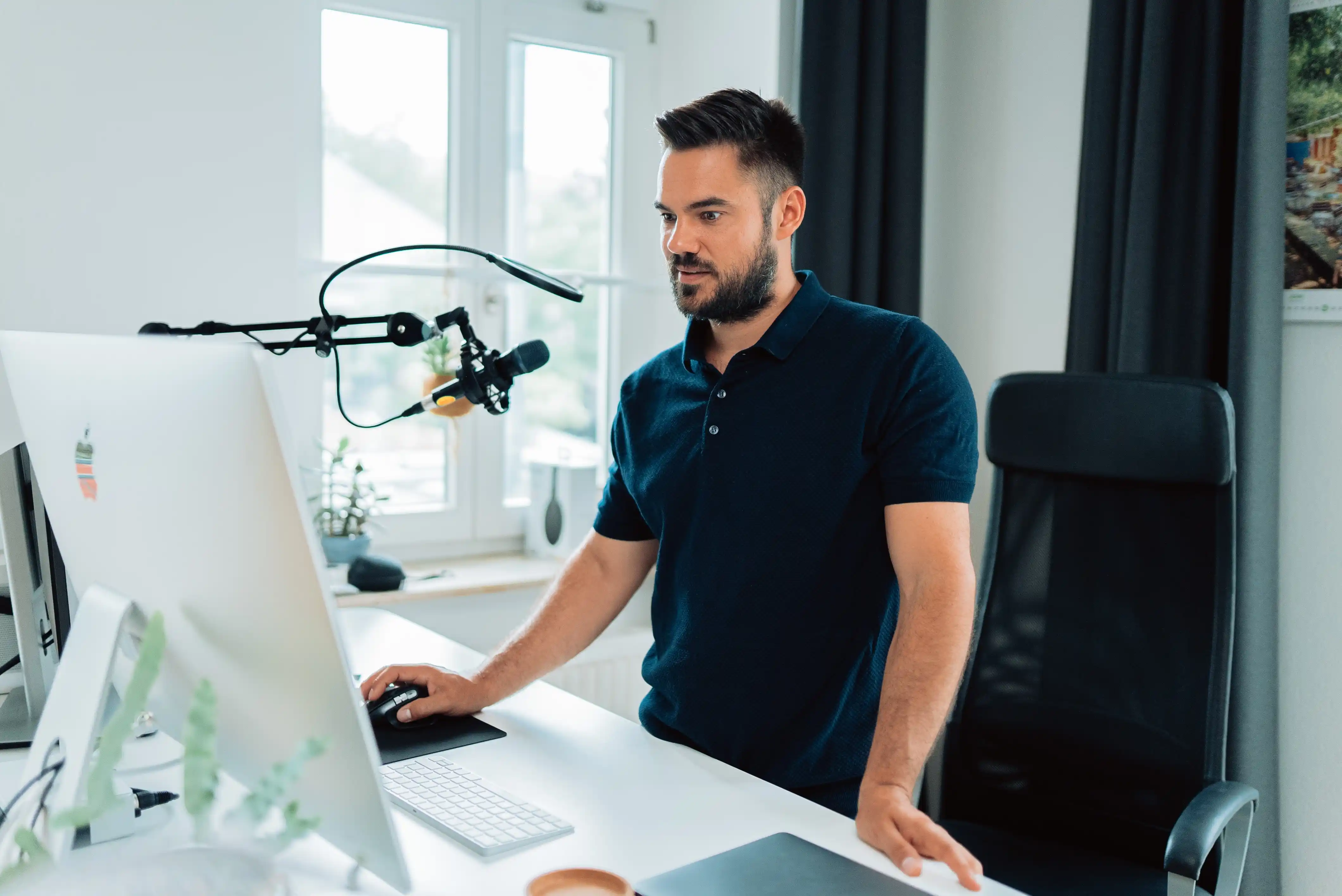 An influencer working at a desk with a computer.