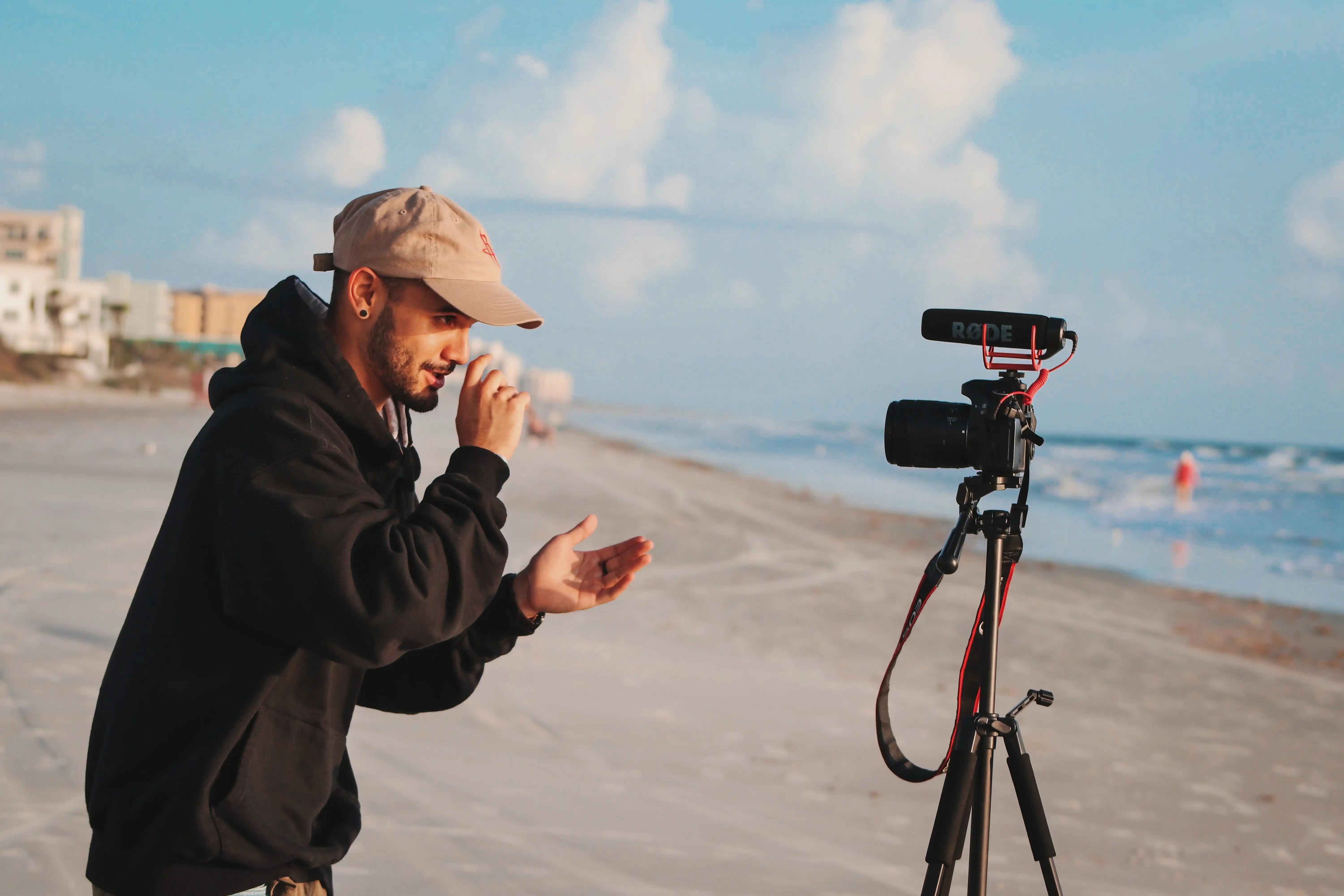 An influencer capturing moments on the beach with his camera.	