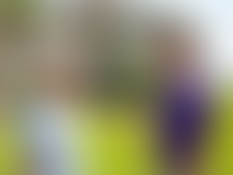 Exterior cleaner safely showing a senior homeowner before and after photos of clean gutters on a smartphone in Wilmington, NC.