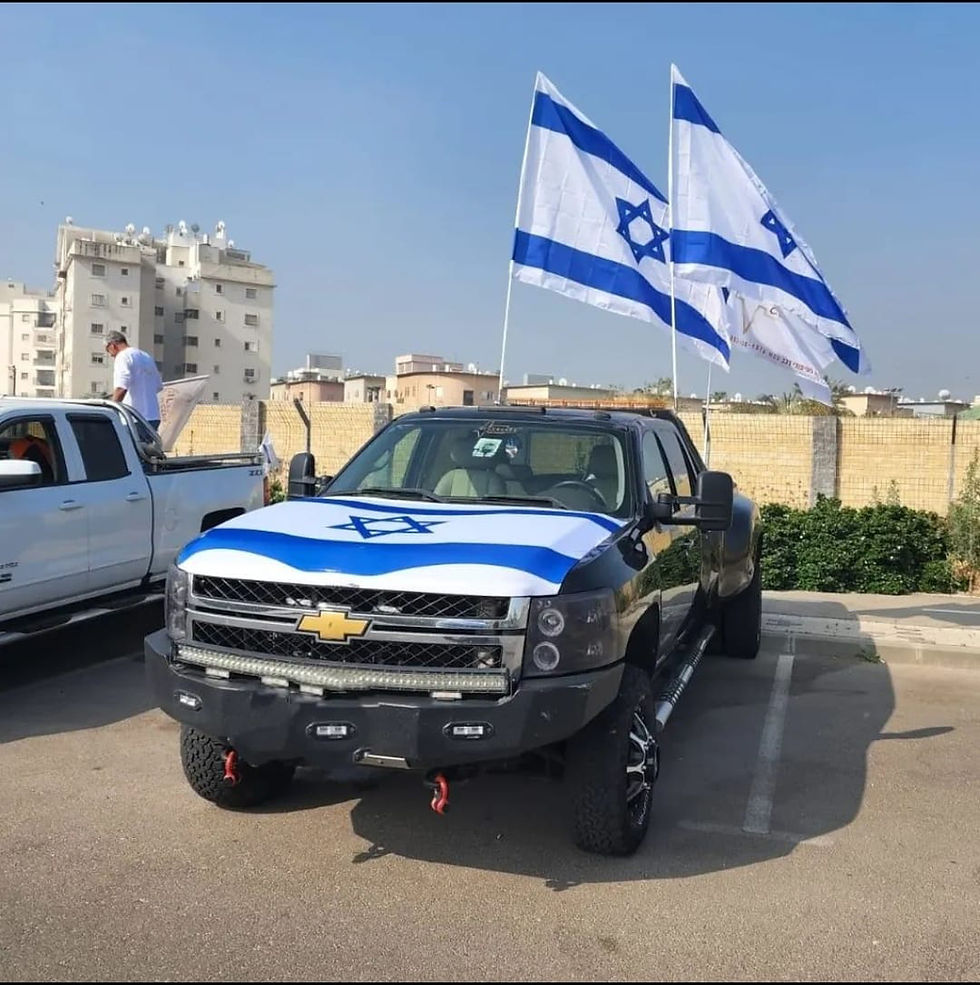 Thumbnail: Black truck with Israel flag hood cover and flags