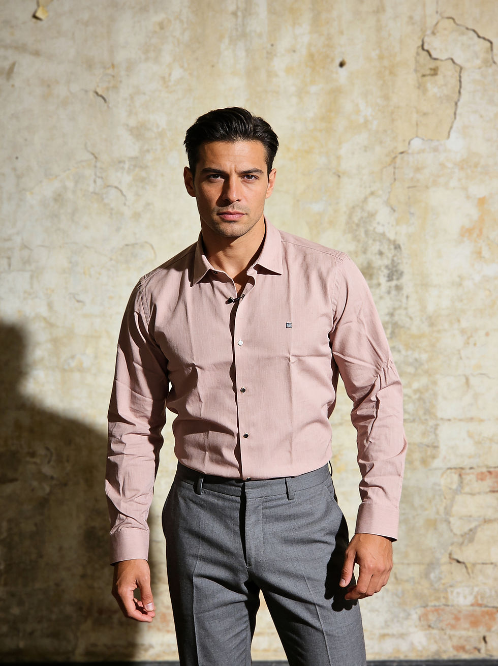 Man wearing a light brown button-up shirt and grey pants