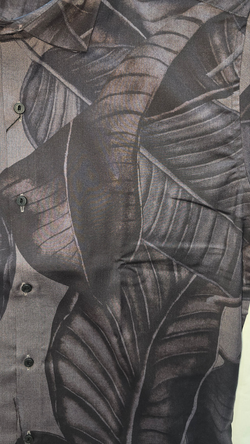 Close-up of shirt with dark leaf pattern