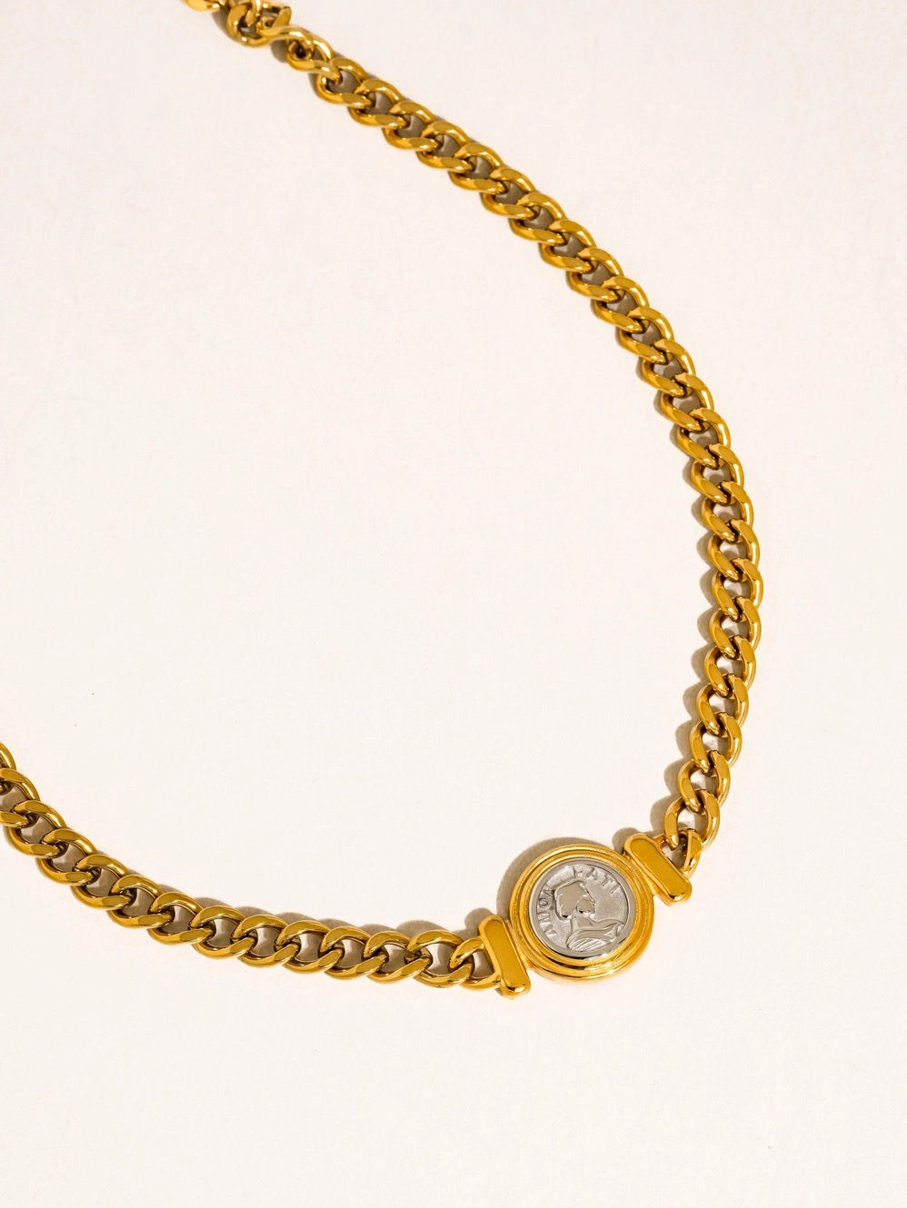 Parisse Coin Pendant on a gold curb chain necklace.