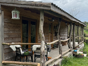 The outside view on Quabbs cabin, including wraparound deck