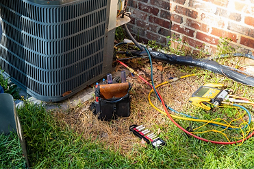 outdoor-ac-unit-being-repaired_edited.pn