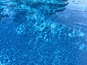 Sunlight reflecting on the surface of a swimming pool