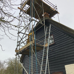Scaffold around a chimney stack on a thatched property.