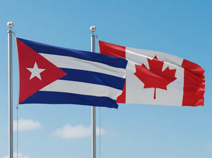 The Cuban Flag and Canadian Flag blowing in the wind together