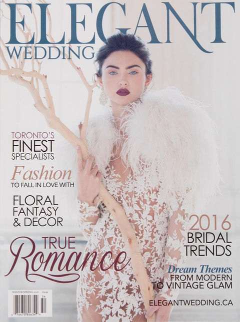 Modern bride in lace dress with feathers as cover of Elegant Wedding Magazine.
