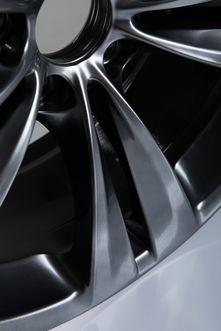Detail of a black and chrome luxury hub cap.