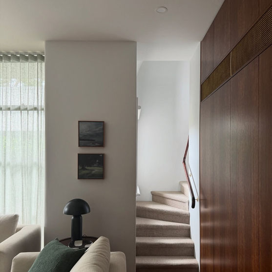 Modern home interior staircase, with downlight lighting.