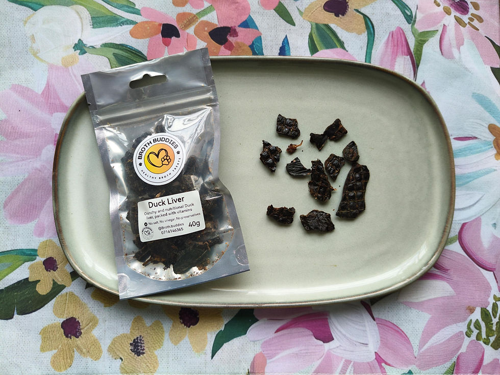 Thumbnail: Broth Buddies 40g crunchy duck liver treat packet with several dark, textured dried pieces on grey ceramic plate