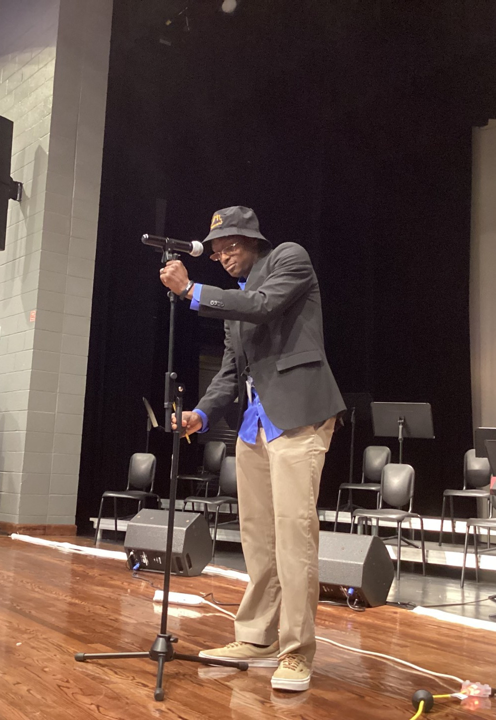 Ryan Farr setting up on stage in Sterling High School's auditorium
