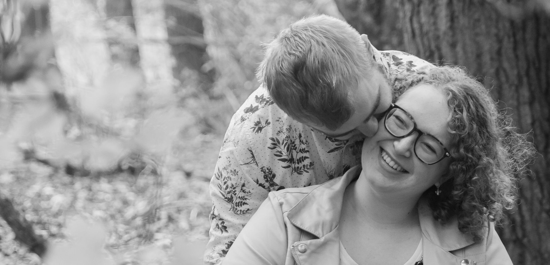 Foto van zoenend koppel in het bos