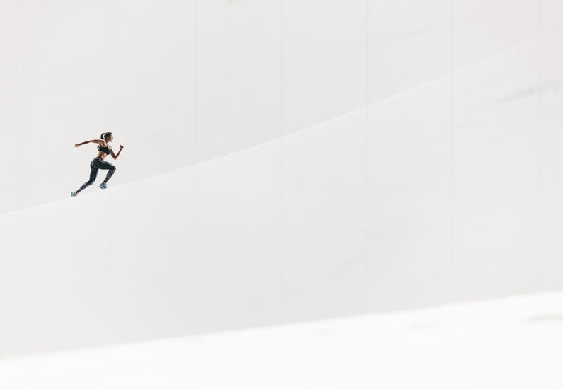 Woman running across a bright minimal landscape, symbolizing independence and personal momentum — representing the Self-Paced Growth Modules at Focal Point Counseling.