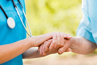 CaregiverAndSeniorManHoldingHands.jpg