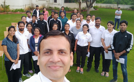 Group photo with Dr. Vivek Modi at an outdoor team event