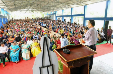Speaker Dr. Modi addressing large audience at event