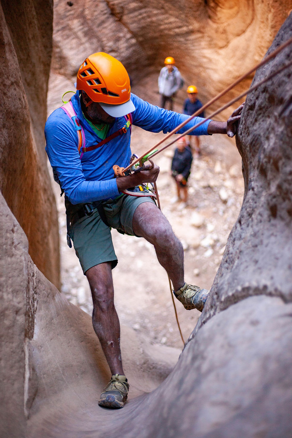 Man rappelling into canyon