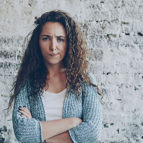 Portrait of angry young lady looking at camera, frowning and expressing disappointment, an