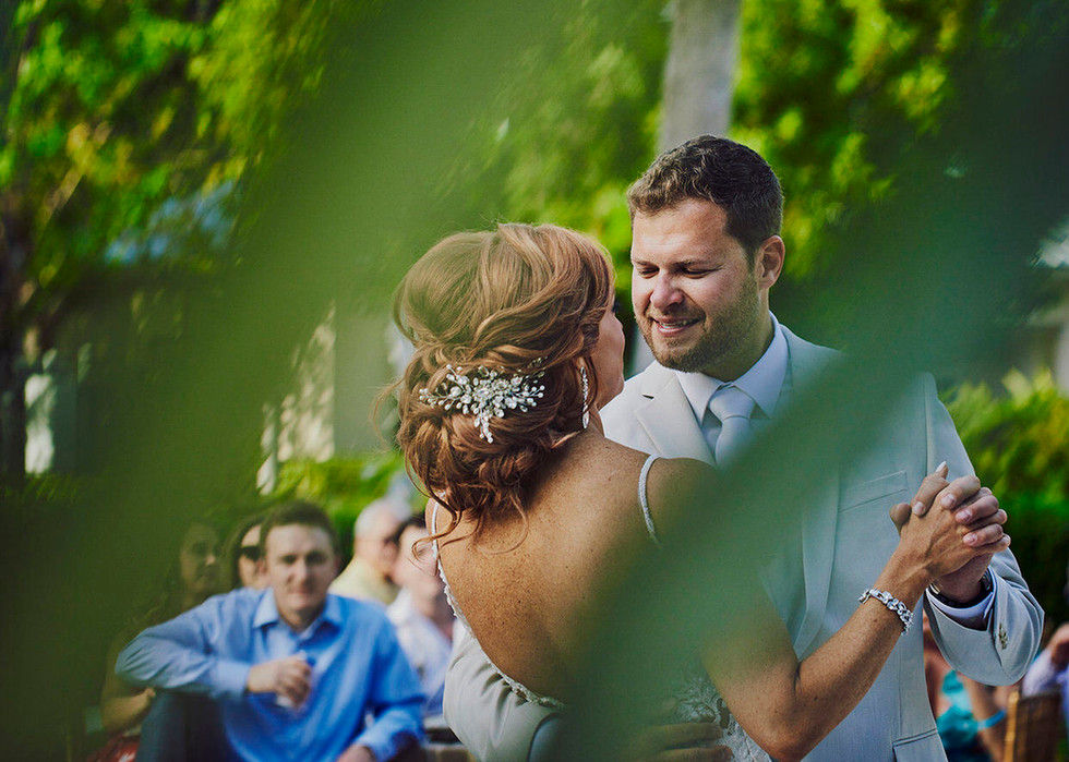 Candid moment between bride and grooms first dance.