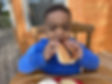 Little boy eating a hotdog