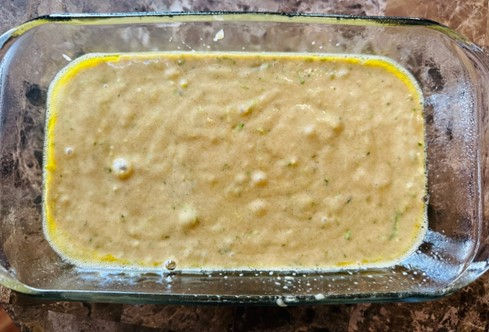 Zucchini bread mixture in glass baking dish
