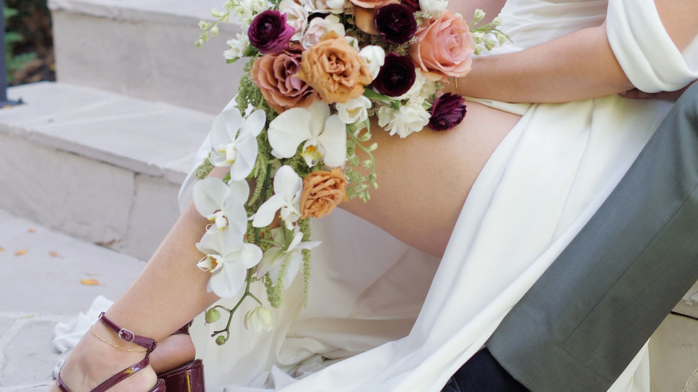 Wedding detail shot, featuring red wedding shoes and cascading wedding bouquet