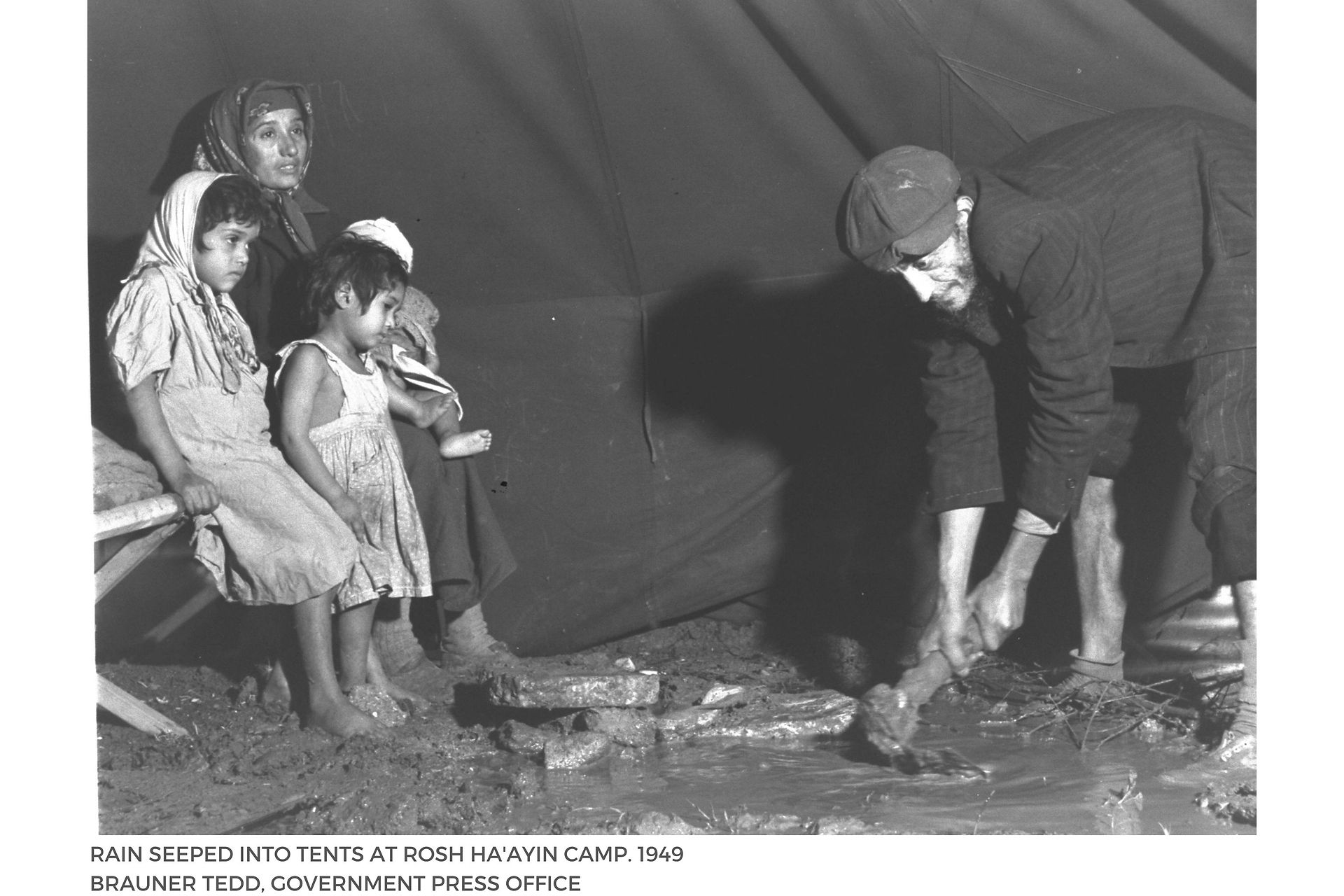 RAIN SEEPED INTO TENTS AT ROSH HA'AYIN CAMP. 1949