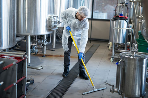 professional-cleaner-wearing-protection-uniform-cleaning-floor-of-production-plant.jpg