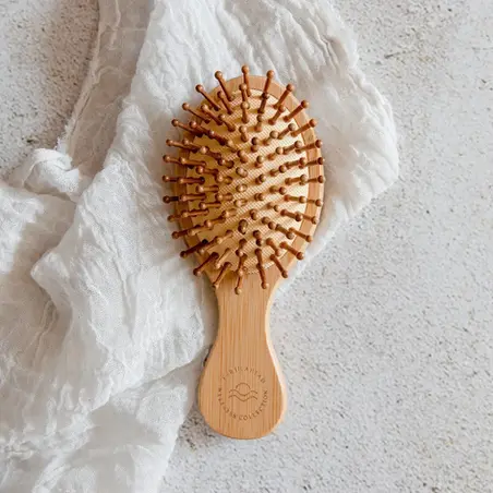 Eco-friendly bamboo hair brush, lightweight and compact, ideal as a sustainable stocking stuffer for hair care.