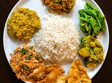 Traditional Sri Lankan rice and curry served with vegetables, lentils and crispy papadam in Tangalle