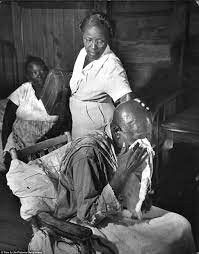 Maude Callen consoles a weeping man who was left unable to walk after a stroke.