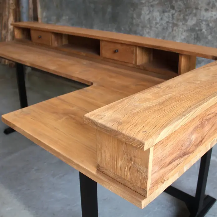 Close-up of a custom corner desk with built-in drawers, featuring premium wood grain and expert craftsmanship by Ed and Coco.