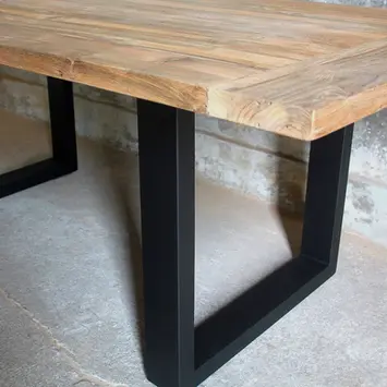 Close-up of brushed teak wood tabletop showing rich grain and natural texture, on powder-coated black metal base.