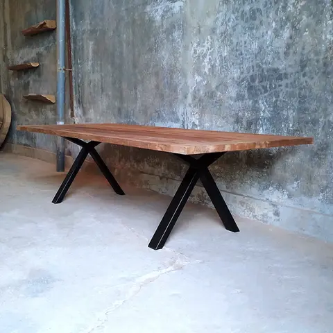 Close-up of black powder-coated V-legs with anti-rust finish supporting solid teak tabletop, part of Ed and Coco’s handcrafted industrial dining furniture.