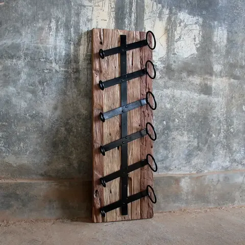 Rustic teak industrial wine rack handmade in Java, Indonesia by Ed and Coco, wall-mounted with iron holders for stylish wine storage.
