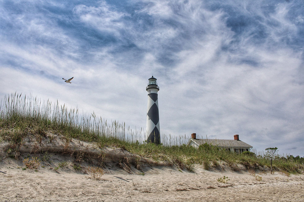 Beach and sky with lighthouse in the background