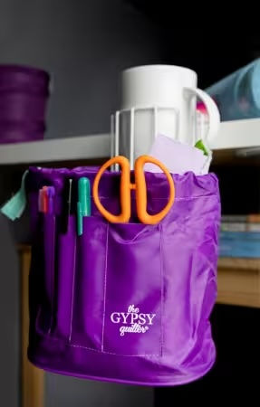 Thumbnail: Front view of the Sensational Sip & Snip cup holder and puple accessory bag with scissors and pens