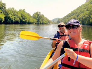 A couple canoeing down the Dordogne River in France