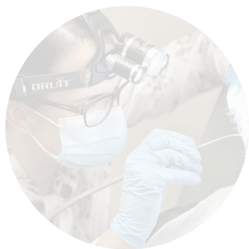 Image of WNDA audiologist undertaking ear wax removal process on a patient, using water pulse irrigation technique