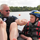 WNDA-Groups-Breakout club-Young service user in a boat receiving instructions on how to water-ski