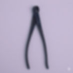 The tool is designed with specialized, rounded "blunt-nose" tips that allow for cutting thick training wire close to the bark
