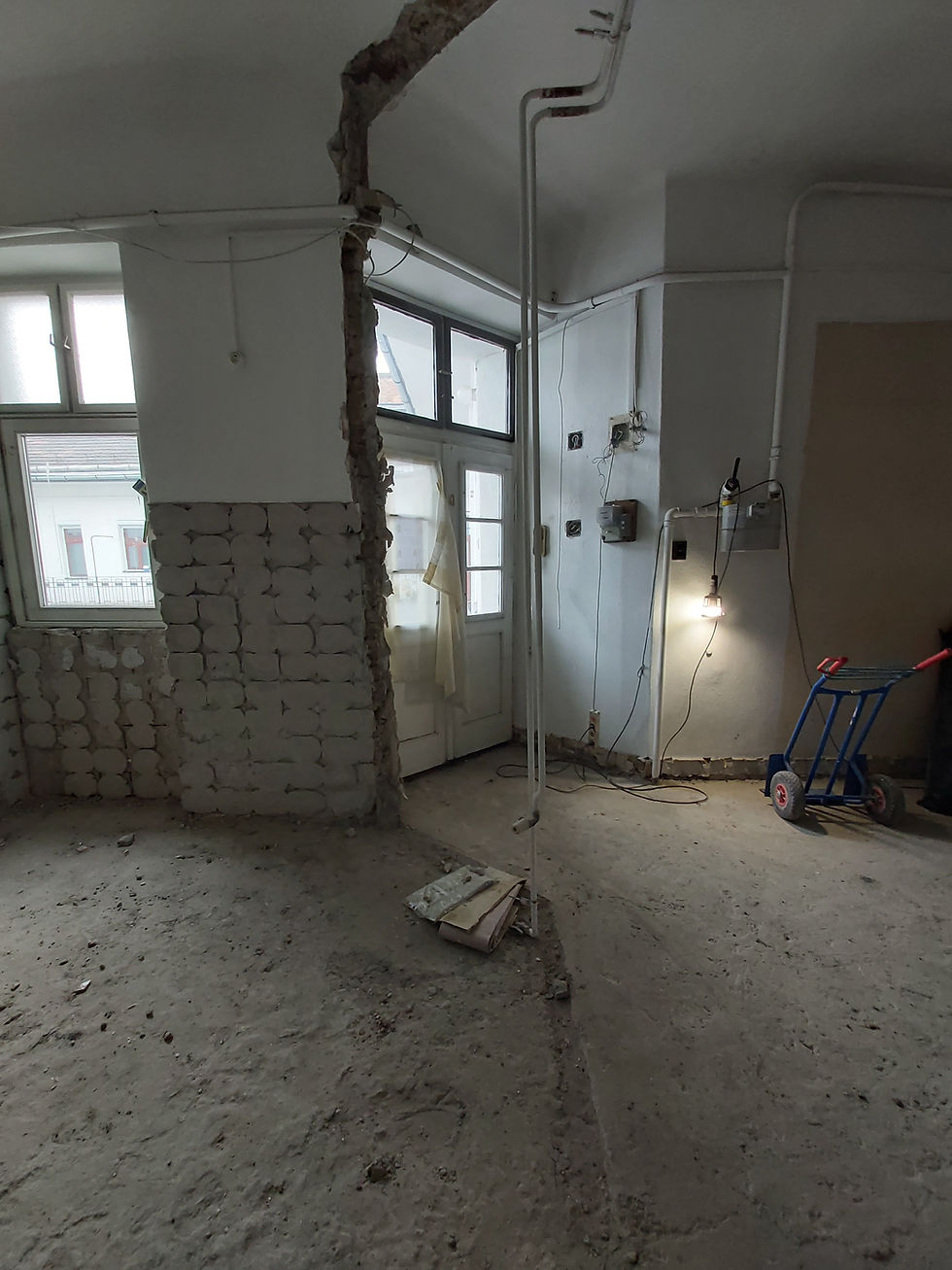 Kitchen walls and floor stripped back during demolition, Karinthy Frigyes Street apartment