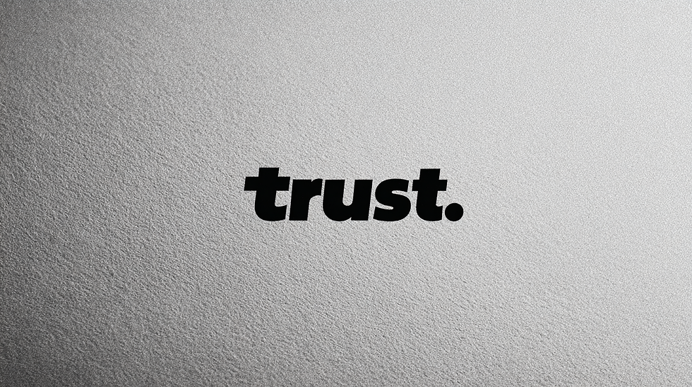 The word trust in bold black letters on textured silver background representing AI Trust Zones concept